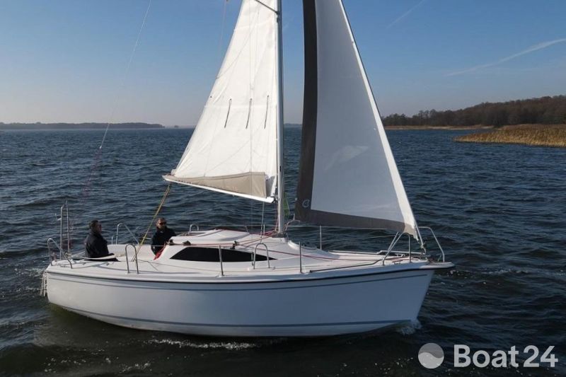 Sasanka Viva 700 sailboat from 2006 sailing on a calm lake under clear skies.
