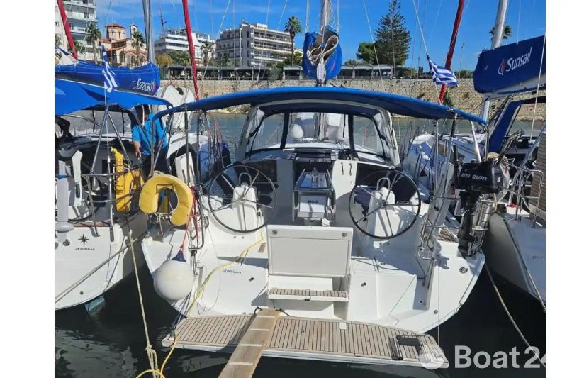 2019 Beneteau Oceanis 41.1 sailboat docked in a marina, featuring dual steering wheels.