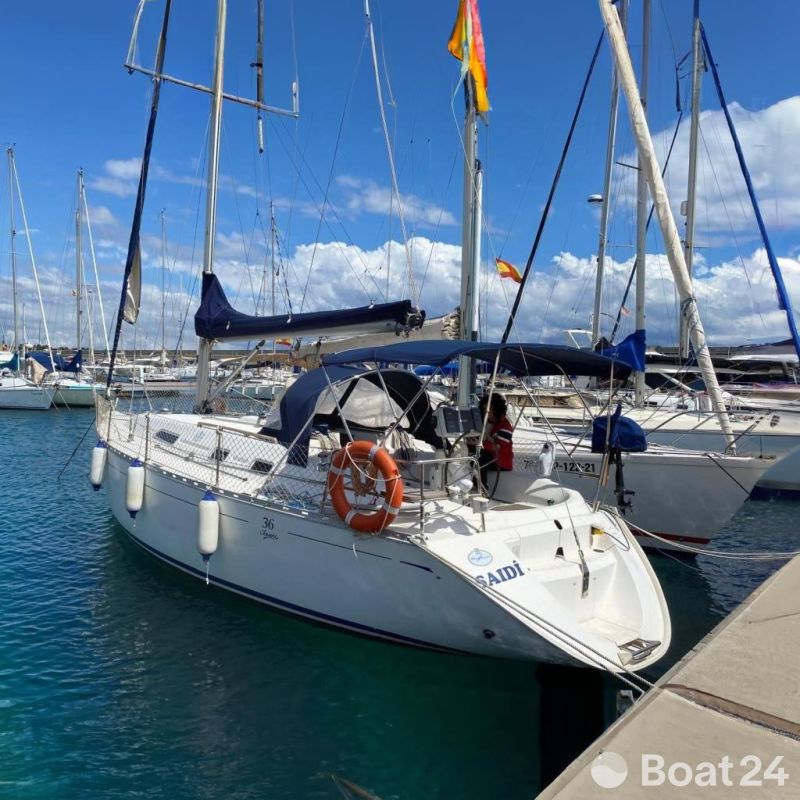 Dufour 36 Classic sailboat docked in marina, 2000 model, clear blue sky.