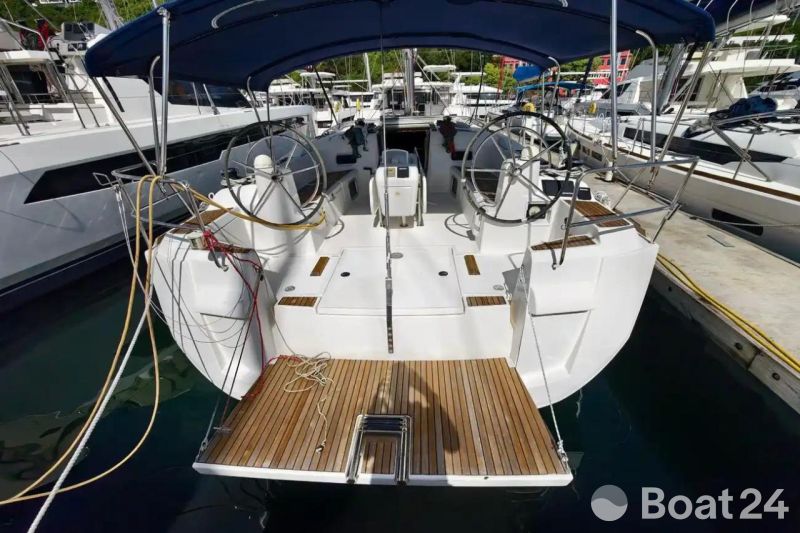 2016 Jeanneau Sun Odyssey 509 sailboat with dual steering wheels, docked at marina.