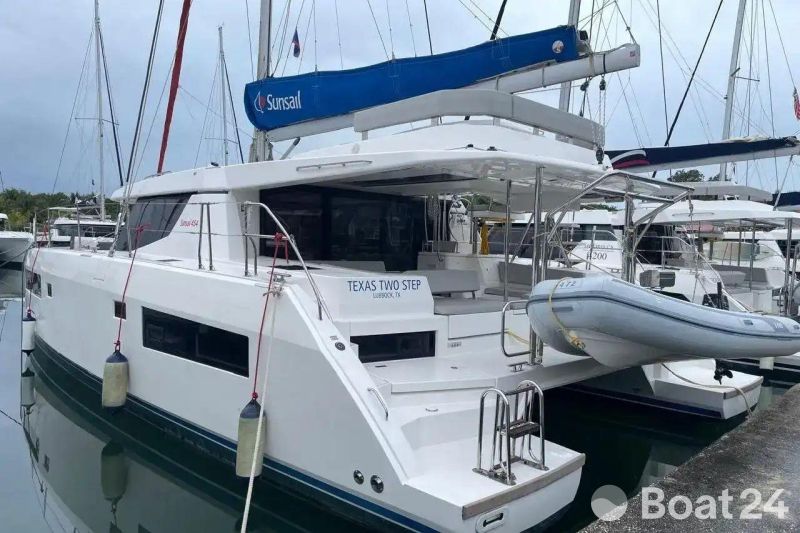 2022 Leopard 45 catamaran docked, featuring Sunsail branding and inflatable dinghy.