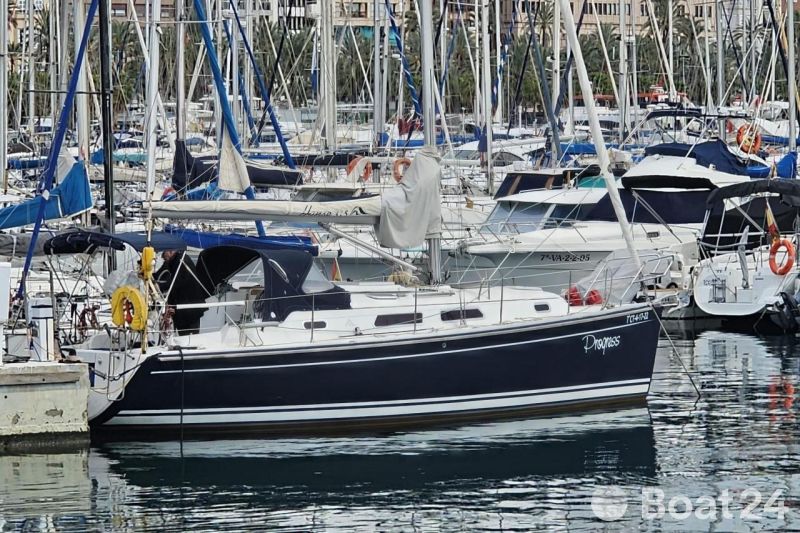 2006 Hanse 315 sailboat docked in a marina, surrounded by other boats.