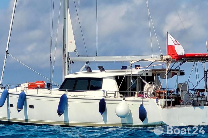 Sailing yacht Moody 45 DS 2020 on calm sea with blue fenders and flag.