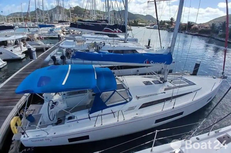 2024 Beneteau Oceanis 461 sailboat docked in a marina with blue canopy.