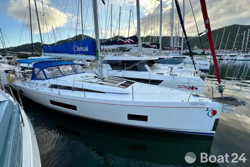 2024 Beneteau Oceanis 46.1 sailboat docked in marina, featuring sleek design and blue canopy.