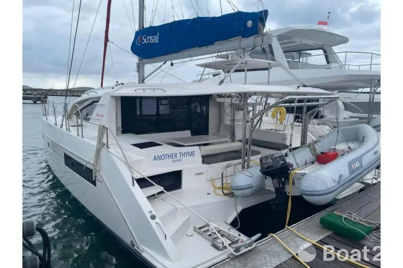 2020 Leopard 40 catamaran docked, featuring a dinghy and Sunsail branding.