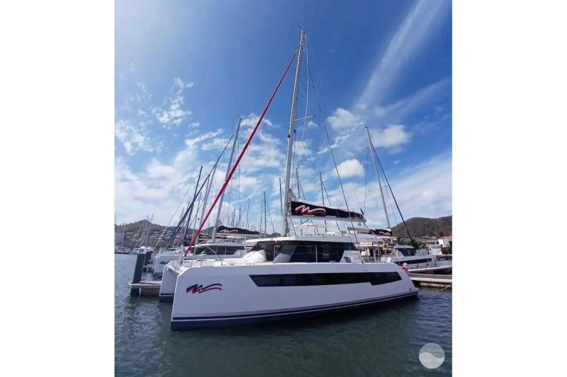 2022 Leopard 42 catamaran docked at marina under clear blue sky.