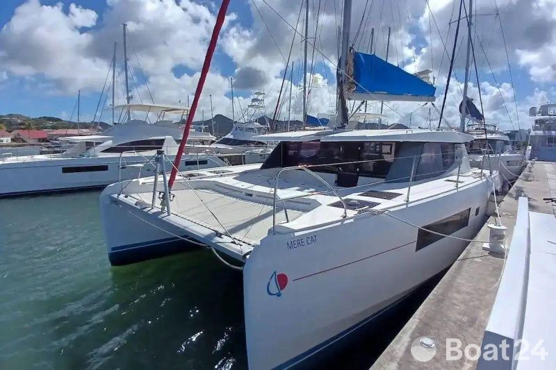 2018 Leopard 45 catamaran docked at marina under blue sky.
