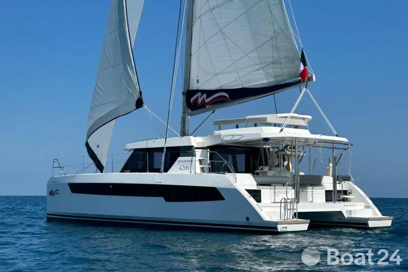 2022 Leopard 42 catamaran sailing on open sea under clear blue sky.