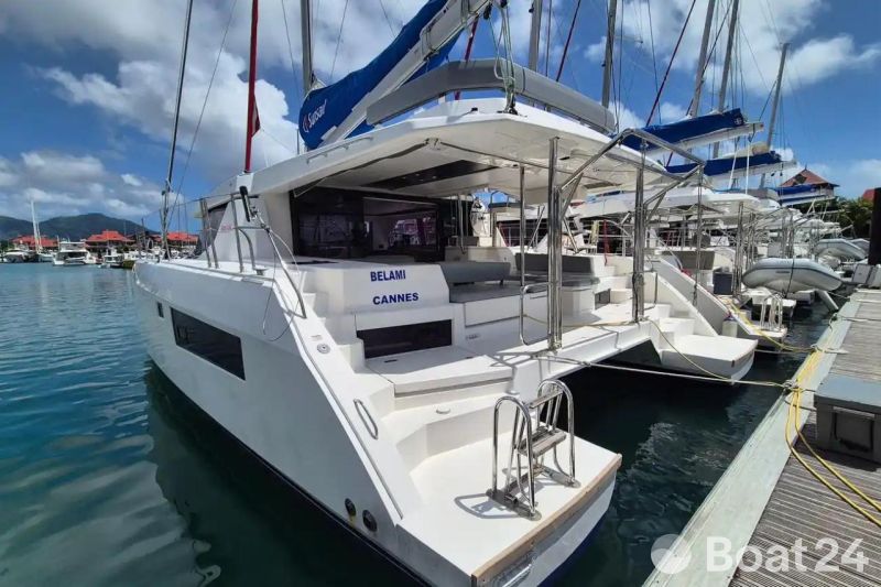 Leopard 45 catamaran docked at marina, 2021 model, sunny day, blue sky.