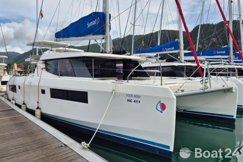2020 Leopard 45 catamaran docked at marina with scenic mountain backdrop.