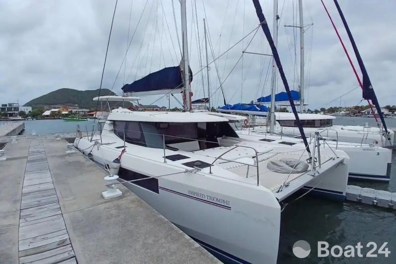 2019 Leopard 45 catamaran docked at marina with scenic background.