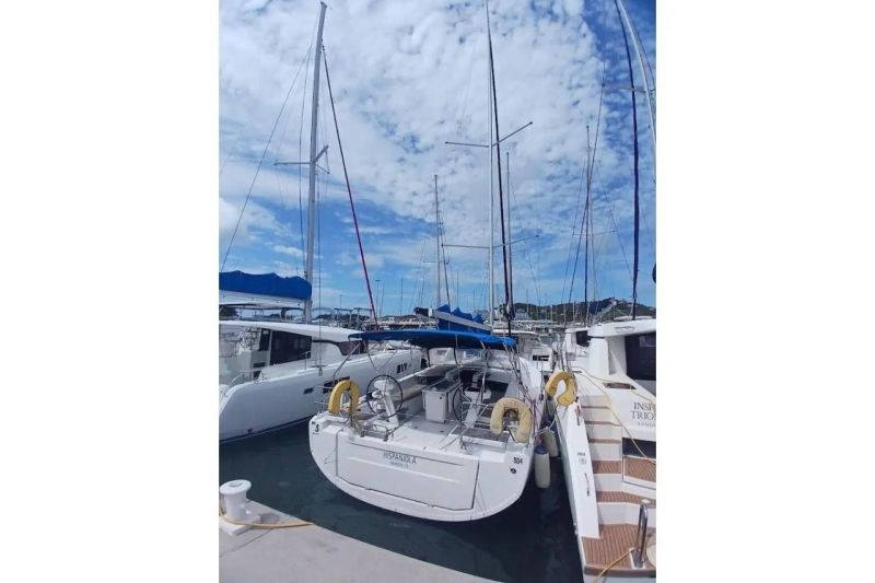 Beneteau Oceanis 46.1 yacht docked at marina, 2020 model, under a partly cloudy sky.