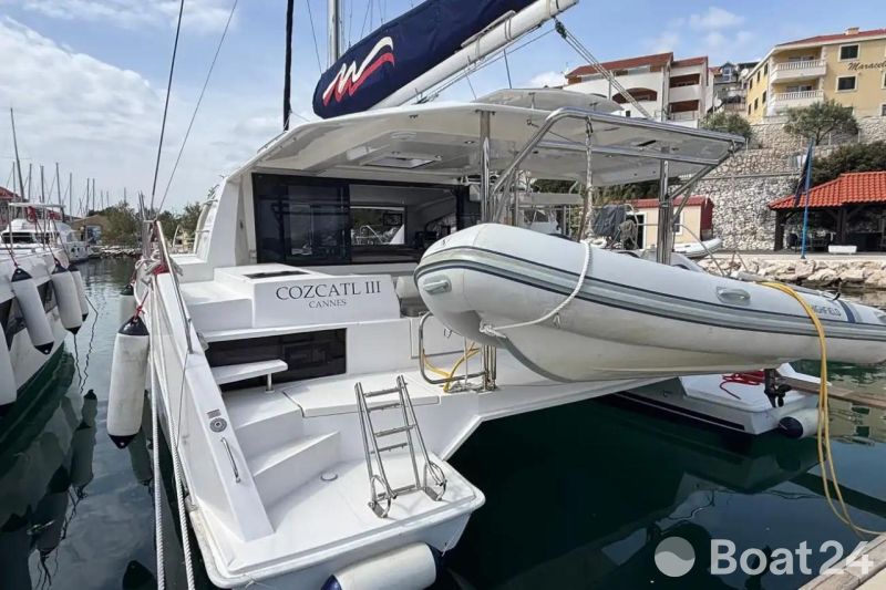 Leopard 40 catamaran, 2020 model, docked with dinghy, named Cozcatl III, in a marina setting.