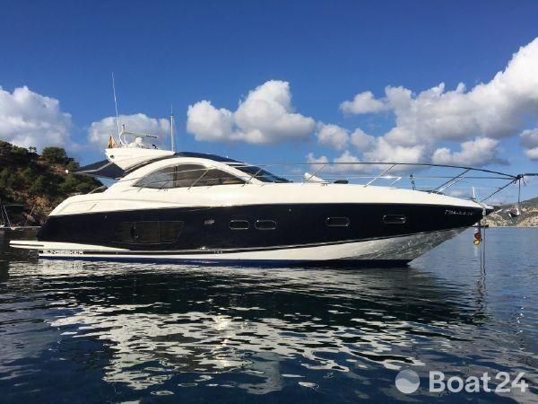2012 Sunseeker Portofino 48 yacht on calm water under a blue sky.