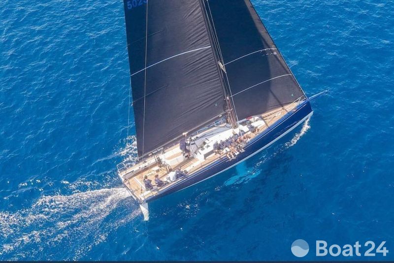 Aerial view of 2019 Nautor Swan Club Swan 50 sailing on clear blue water.