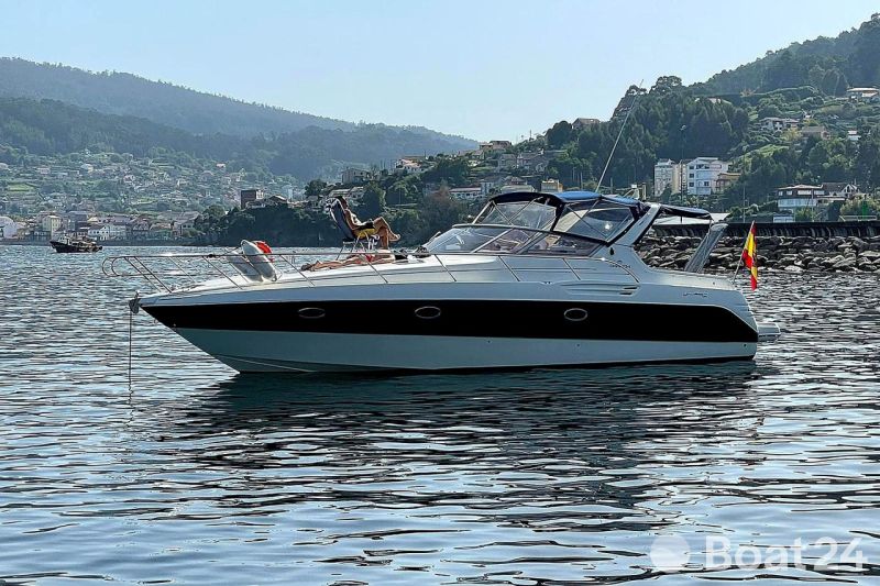 2004 Cranchi Smeraldo 37 yacht anchored in scenic coastal waters.