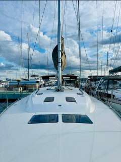 Bavaria 51 Cruiser 2019 sailboat docked at marina under cloudy sky.