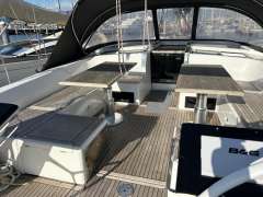 2022 Hanse 510 yacht cockpit with wooden flooring and dual tables.