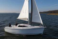 Sasanka Viva 700 sailboat from 2006 sailing on a calm lake under clear skies.