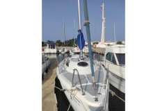 Sasanka Viva 700 sailboat docked at marina, 2006 model, clear sky background.