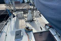 2005 Dufour 40 Performance sailboat cockpit with steering wheel and ropes, docked at marina.