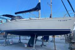 Dufour 36 Classic sailboat from 2000 on dry dock, blue sky background.