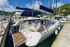 2016 Jeanneau Sun Odyssey 509 sailboat docked at marina, featuring dual steering wheels.
