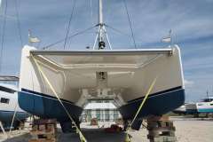 2020 Leopard 45 catamaran on land, supported by blocks, under a clear sky.