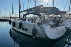 2018 Hanse 588 yacht docked in marina, featuring sleek design and modern amenities.