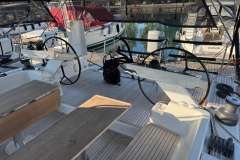 Cockpit of 2018 Hanse 588 yacht with dual steering wheels and wooden seating.