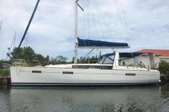 2013 Beneteau Oceanis 41 sailboat docked, featuring sleek design and blue sail cover.