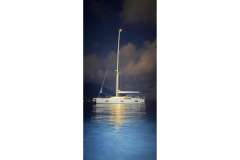 Nautor Swan 48 yacht illuminated at night on calm waters, 2022 model.