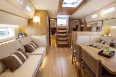Luxurious interior of 2022 Nautor Swan 48 yacht with elegant seating and dining area.