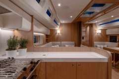Luxurious interior of 2022 Nautor Swan 48 yacht with modern kitchen and seating area.