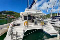 2021 Leopard 50 catamaran docked in a scenic marina with lush hills.