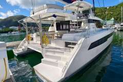 Luxury Leopard 50 catamaran docked in scenic marina, 2021 model.