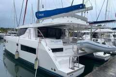 2022 Leopard 45 catamaran docked, featuring Sunsail branding and inflatable dinghy.