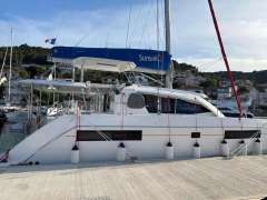 2019 Leopard 40 catamaran docked at marina, featuring Sunsail branding and scenic background.