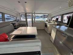 Spacious interior of 2019 Leopard 40 catamaran with modern kitchen and dining area.
