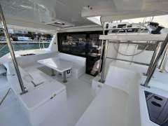 Spacious interior of a 2019 Leopard 40 catamaran with modern seating and helm station.