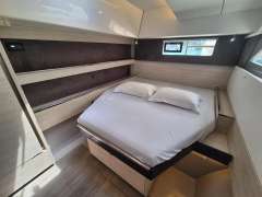 Luxurious bedroom interior of 2020 Leopard 50 yacht with modern design and cozy bedding.