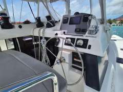 Helm of a 2020 Leopard 50 yacht with navigation controls and steering wheel.