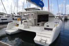 2020 Lagoon 42 catamaran docked in marina, featuring spacious deck and modern design.