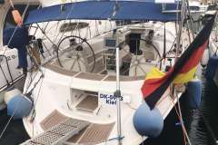 Bavaria 44 sailboat, 2002 model, docked with German flag, Kiel registration.
