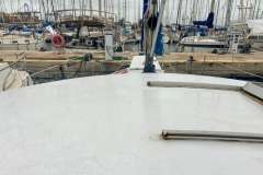 Sailboat deck view in marina, Mascot 28, 1986 model, surrounded by docked boats.