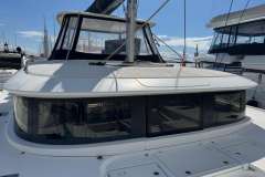 2022 Lagoon 46 catamaran with sleek design and modern windows, docked at marina.
