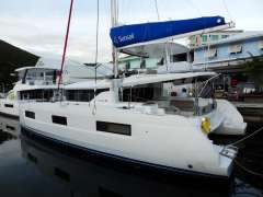 2020 Lagoon 46 catamaran docked, featuring sleek design and spacious deck.