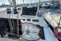 Helm of 2022 Leopard 42 catamaran with navigation equipment in marina setting.