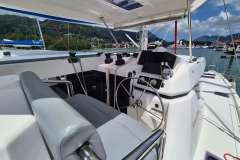 Helm of 2021 Leopard 45 catamaran docked in scenic marina setting.